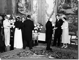 James Russel Barnes, Jr. making a floral presentation while the King and Queen of England are being greeted on the right